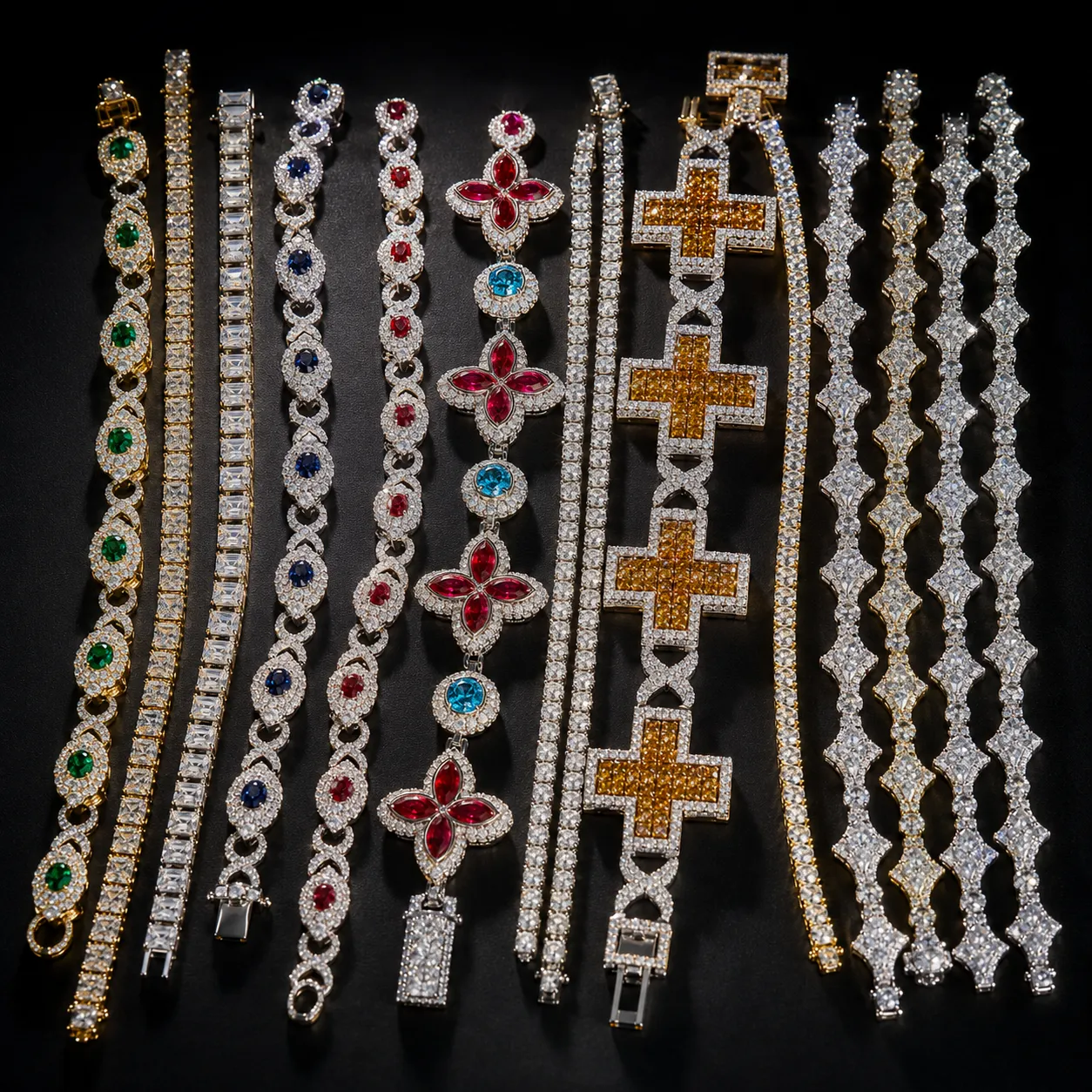 A flat-lay collection of iced-out chains, tennis bracelets, cross pendants and gemstone cluster pieces