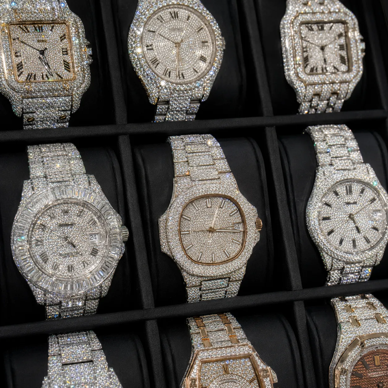 A display case of fully iced-out moissanite watches in silver and rose gold