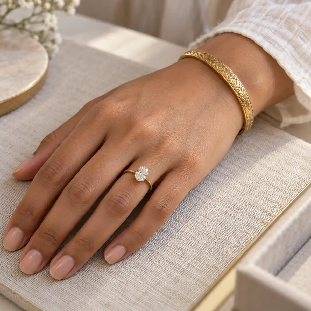 Close-up of a 22ct yellow gold South Asian engagement ring with reinforced claw setting, shown beside a bespoke bridal jewellery commission at a specialist UK atelier